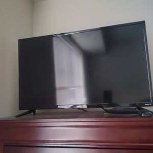 On Running Black Flat-Screen TV with Stand